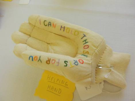 soft sculpture hand with embroidered text