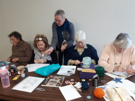 teacher and students create Dorset buttons