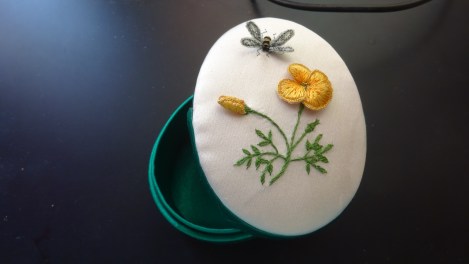 box with yellow stumpwork flower
