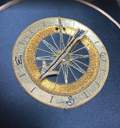 gold and silver compass on blue fabric