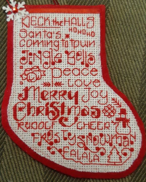 Christmas stocking embroidered in red with Christmas themed words