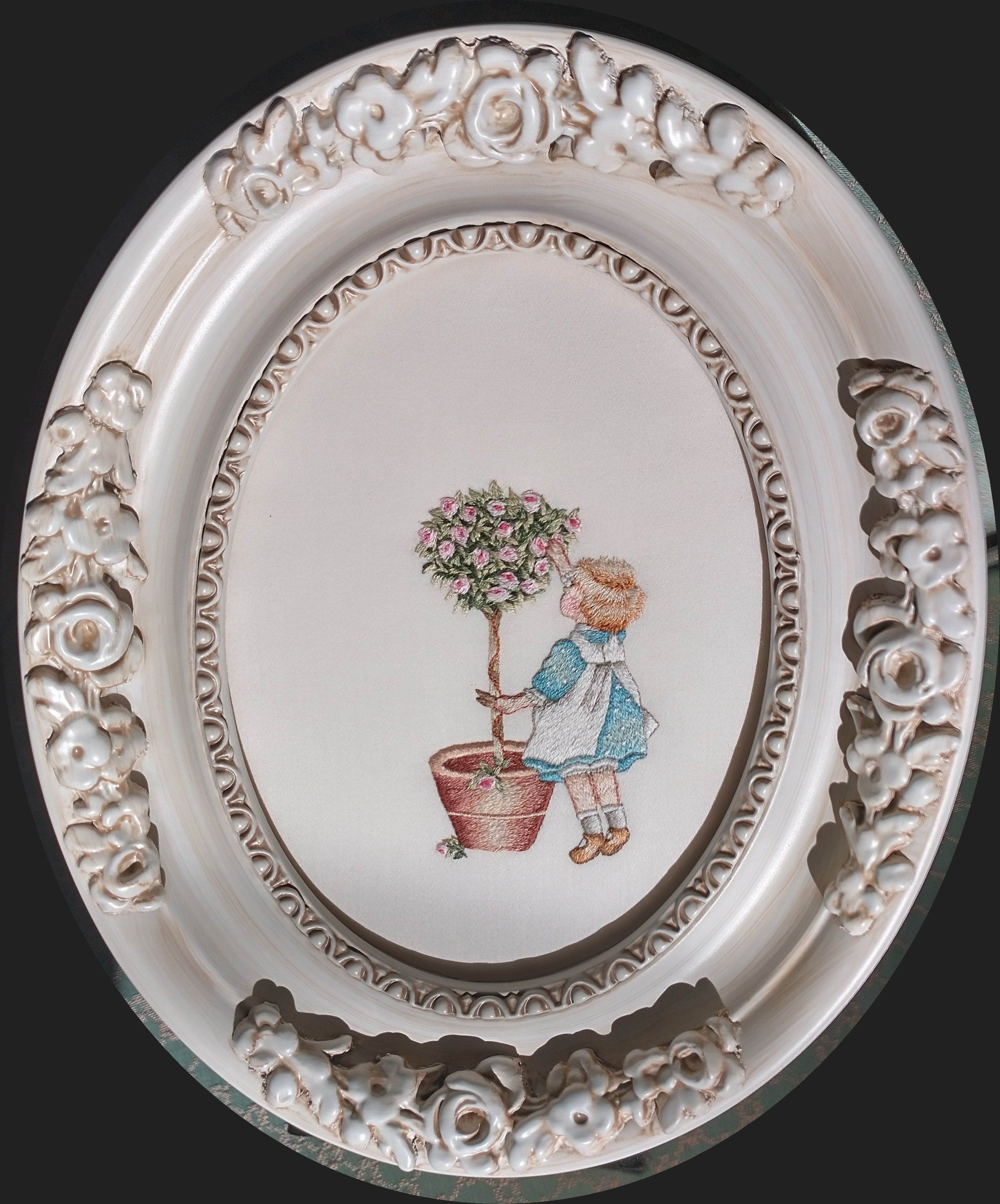 thread painted image of girl with flowered tree