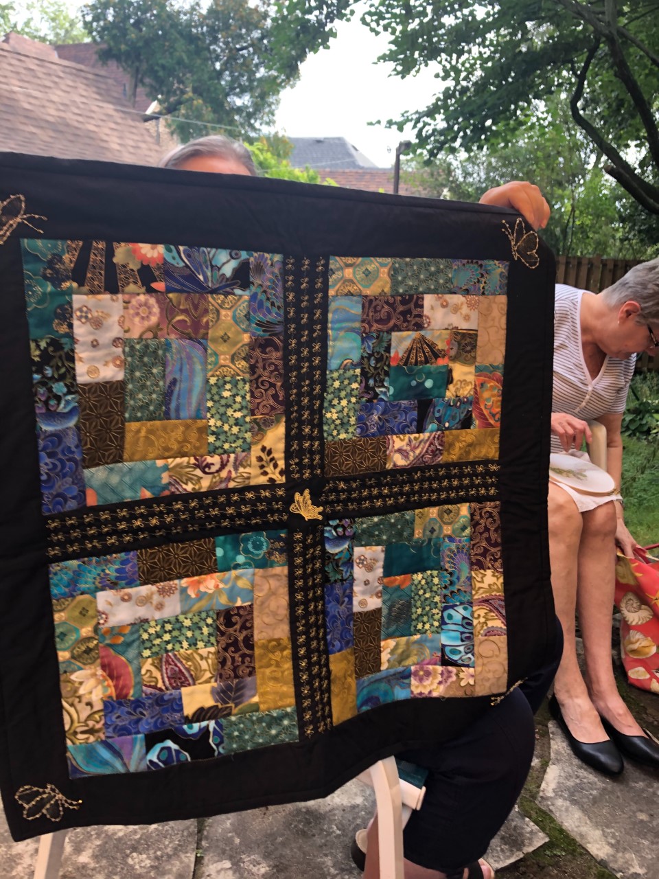 quilt with 4 large blocks in browns, greens, blues