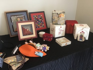 long shot of a table full of embroideries