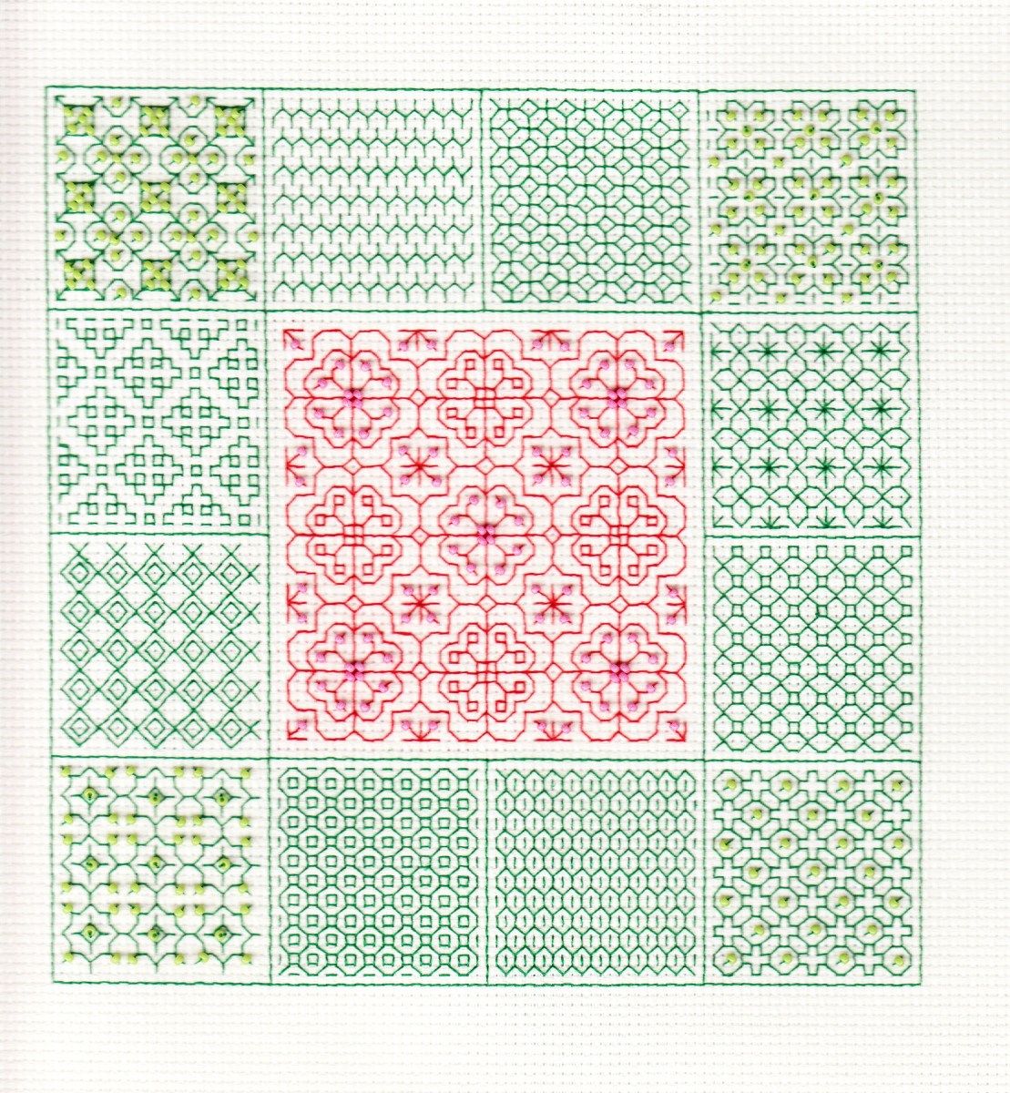 blackwork done in red and green with beads incorporated