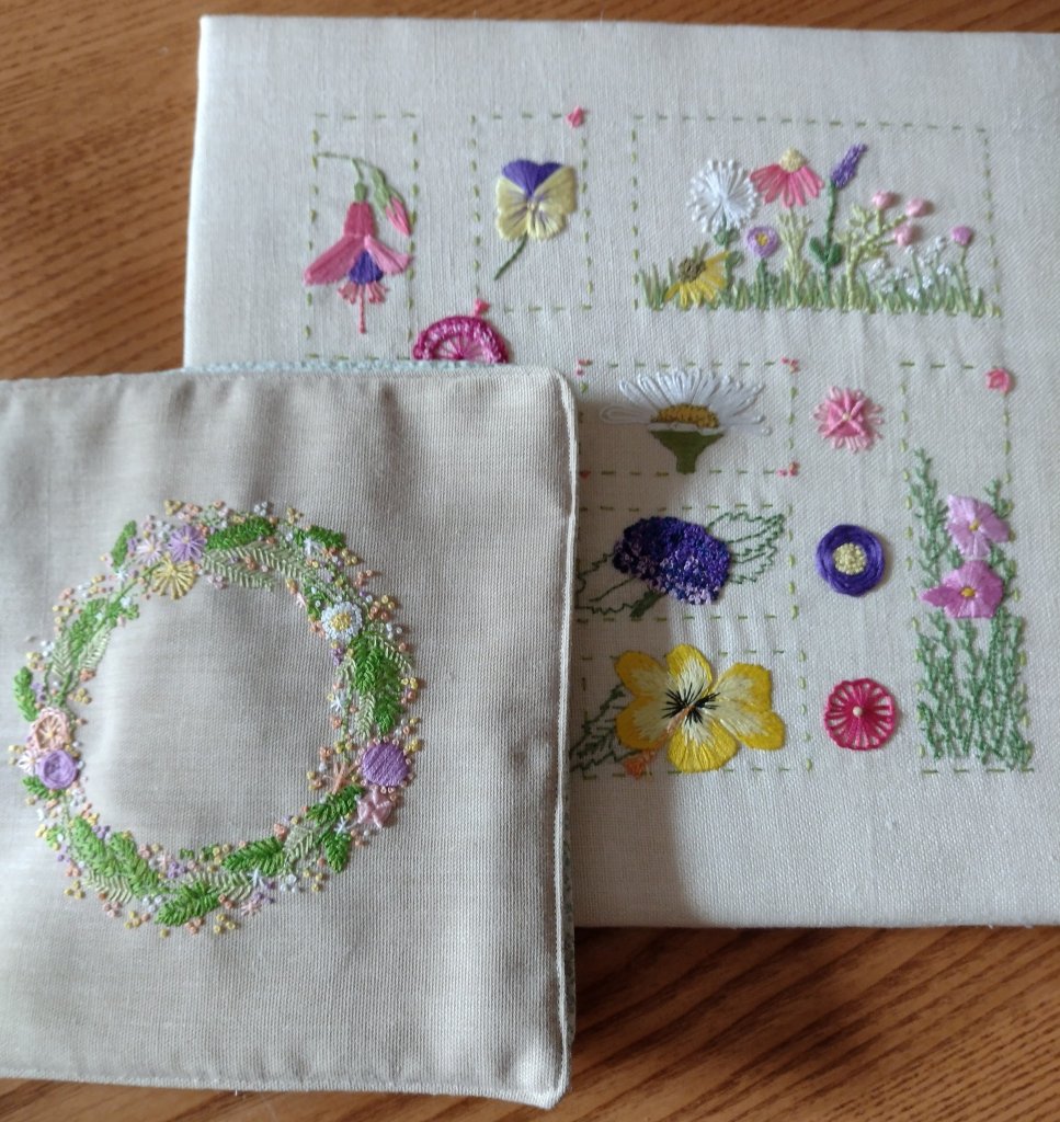 cushion with circlet of embroidered flowers and embroidered flower sampler