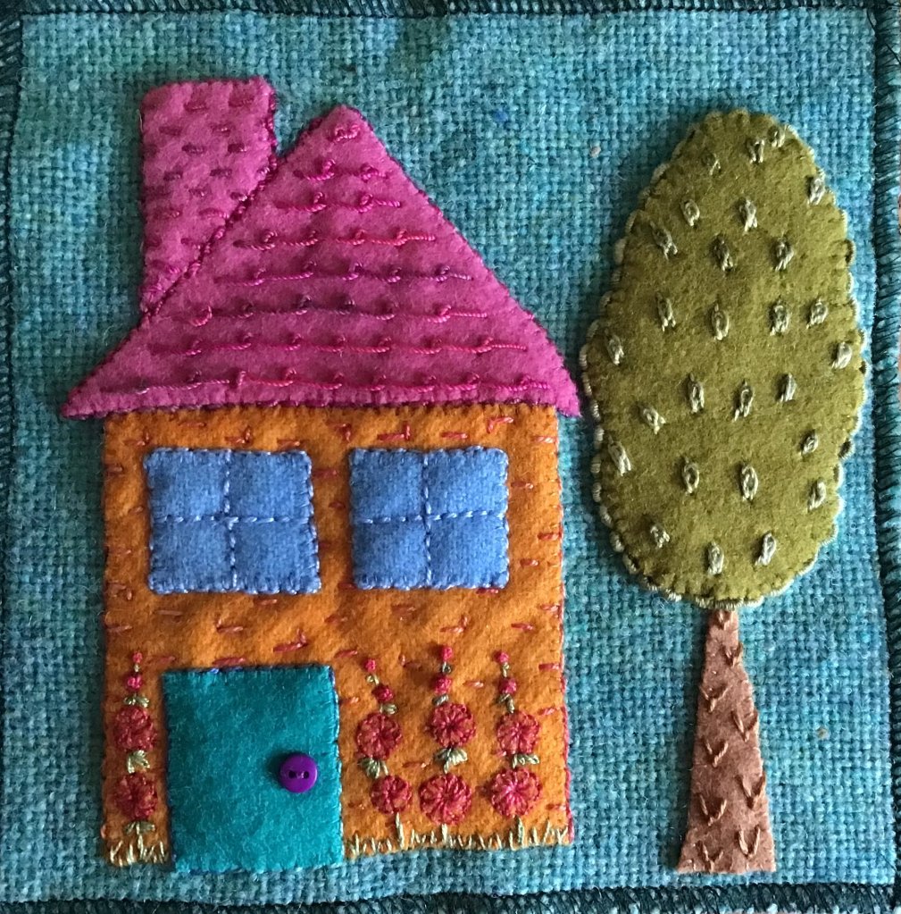 wool applique image of colourful house and tree embellished with stitches