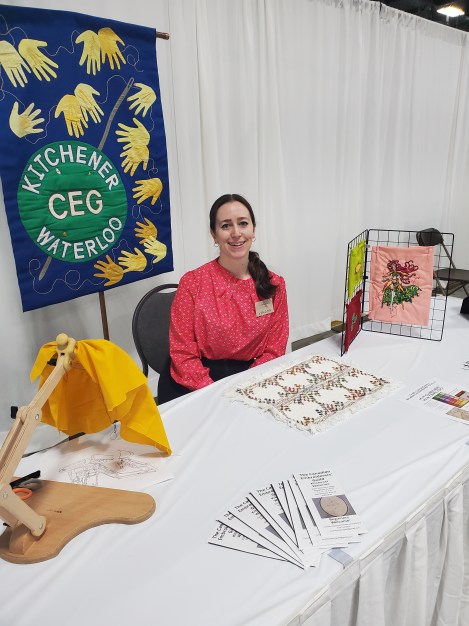 woman seated at table with brochures