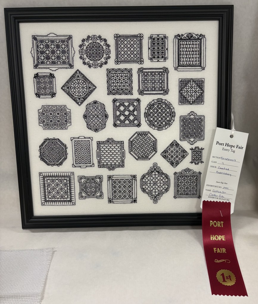 25 blackwork squares, as a sampler, framed