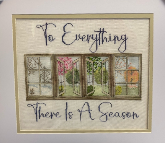 cross-stitch with 4 scenes from the same window showing 4 seasons