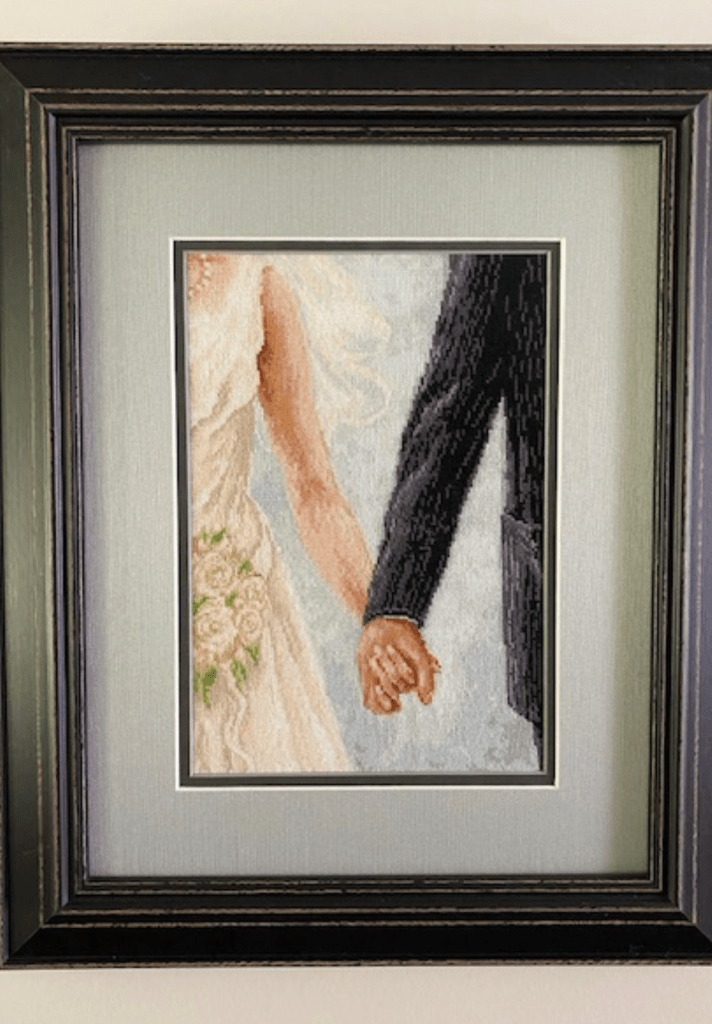 image of bride and groom holding hands showing only the arms and hands