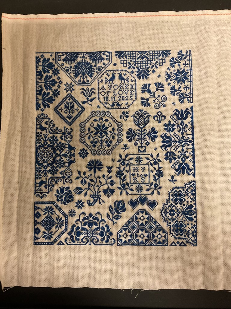 fine, dark blue stitching on unbleached linen in a multitude of circle motifs