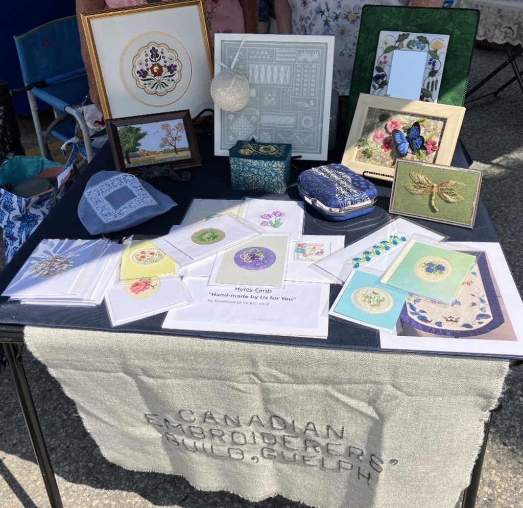 a display of various embroidered items, on a table