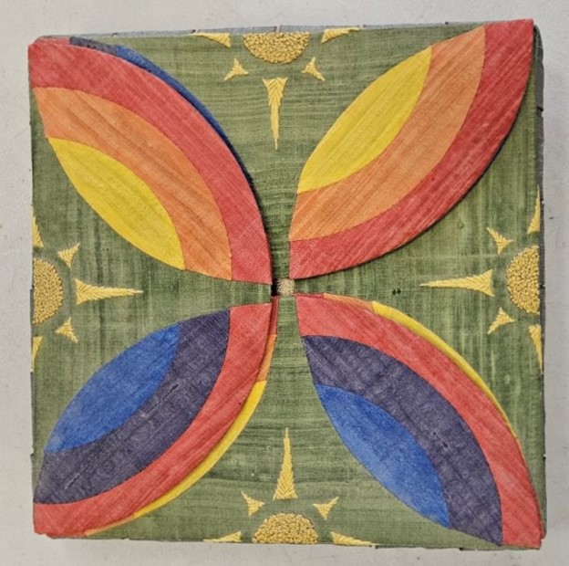 a large folding case with flaps appliqued with rainbow motifs