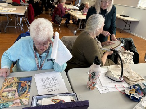 women embroidering at tables
