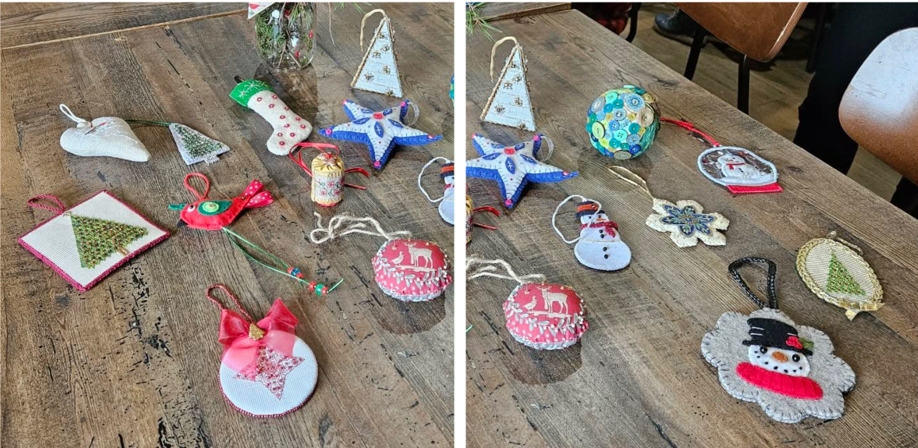 a table showing a variety of hand-stitched Christmas ornaments