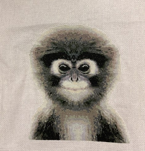 black and white cross-stitch image of a cute monkey