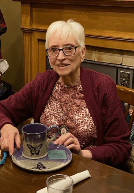 a woman holding a plate and matching coffee cup