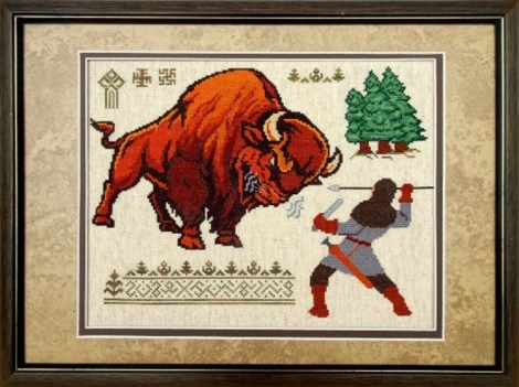 cross-stitch image of ancient warrior with spear facing a large bison-like animal