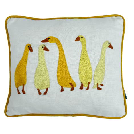 cushion showing 5 stylized geese in yellows and oranges