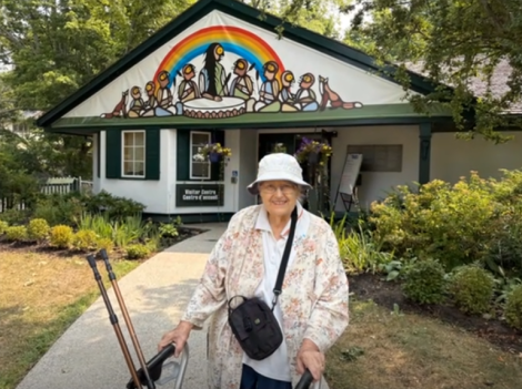 smiling woman in front of a building