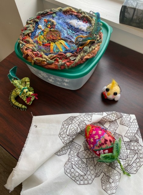 several pieces of embroidery on a table