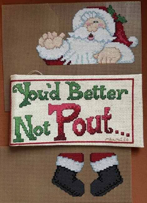 cross-stitch of a Santa figure and sign "You'd Better Not Pout"