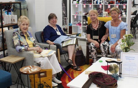 a group of 4 women in easy chairs